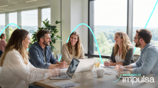 Santalucía Impulsa Equipo de trabajo colaborando en una reunión en oficina con ordenadores portátiles, programa Santalucía Impulsa